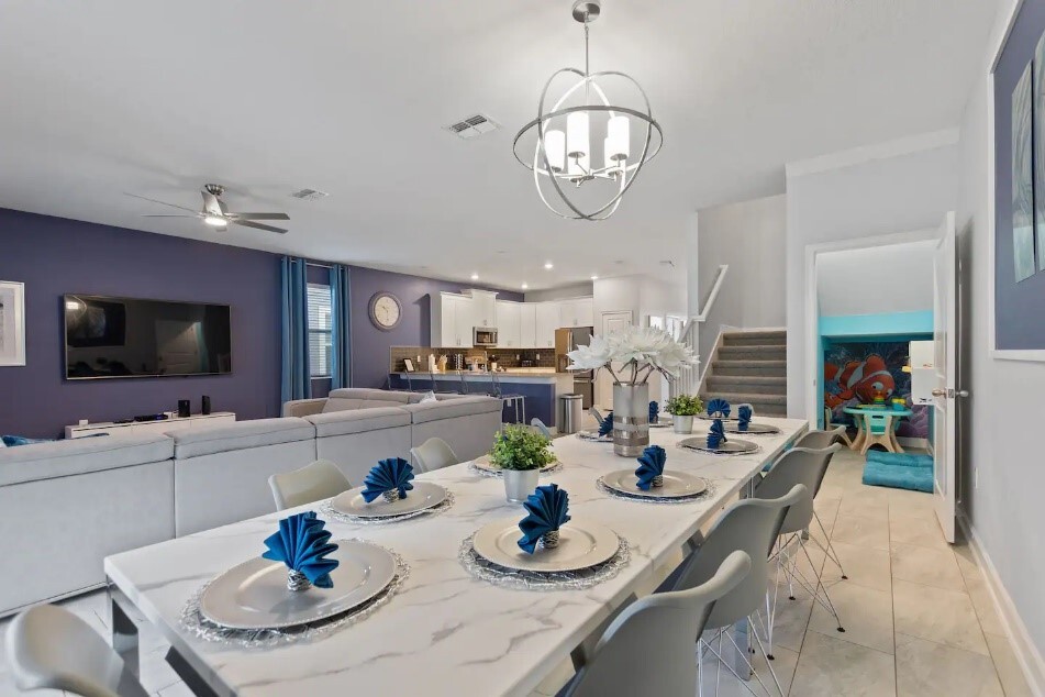 A dining room table with plates and silverware on it.