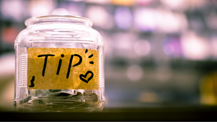 A jar with tip written on it