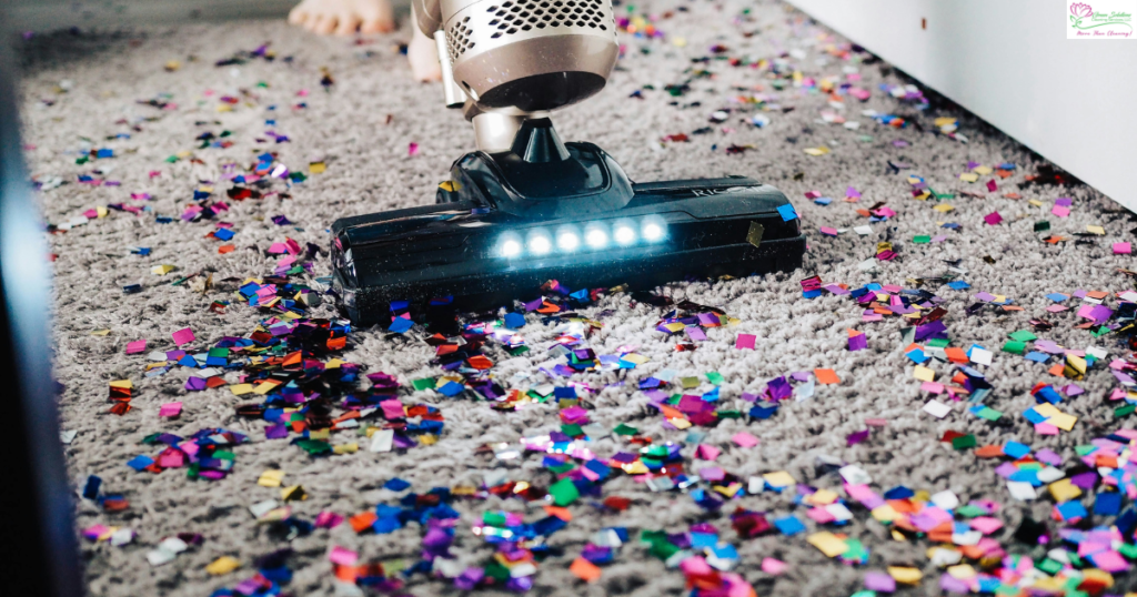 A vacuum cleaner is on the floor with confetti.